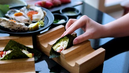 Making Sushi roll with crab meat and sesame seeds. High quality 4k footage