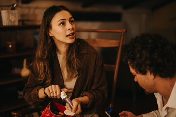 Two people engaged in a discussion indoors, highlighting personal care items and communication.