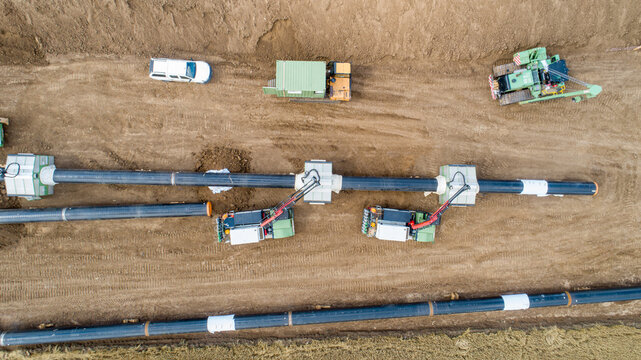 Gas and oil pipeline construction. Pipes welded together. Big pipeline is under construction. Aerial view