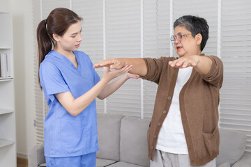 Obraz premium Elderly, nurse, caregiver, patient, healthcare — Happy senior woman raises both arms after physical therapy session with female nurse, showing improvement, strength, and successful aging caregiving