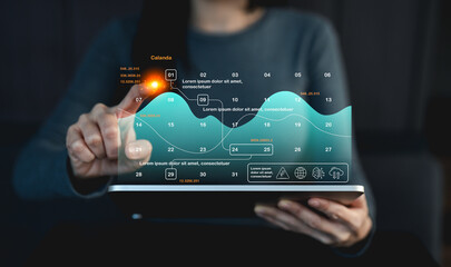 A person interacts with a futuristic transparent tablet displaying dynamic data charts and analytics in a dark tech environment.