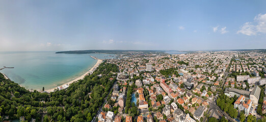 Aerial panoramic view of Varna, Bulgaria, showcasing the urban landscape with red rooftops, green...