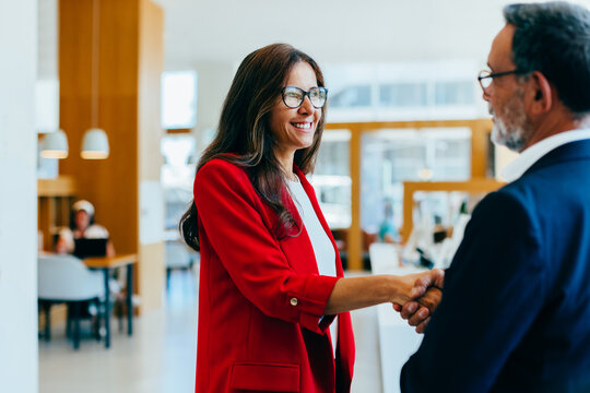 Business professionals shaking hands in an office setting