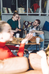 Interested friends talking while resting at house party