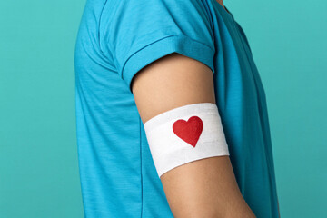 Person arm blue shirt white band red heart image