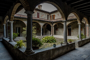 Historic Stone Monastery With Inner Courtyard And Arched Walkways: Peaceful Cloister Architecture In Northern Italy