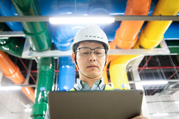asian male engineer is working on a Cooling system pipeline