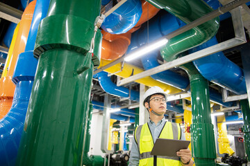 asian male engineer is working on a Cooling system pipeline