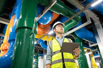 asian male engineer is working on a Cooling system pipeline