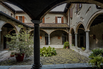 Historic Stone Monastery With Inner Courtyard And Arched Walkways: Peaceful Cloister Architecture In Northern Italy