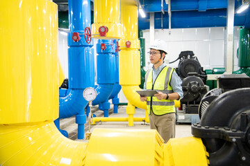 asian male engineer is working on a Cooling system pipeline