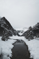 Winter landscape with snow-covered mountains and creek