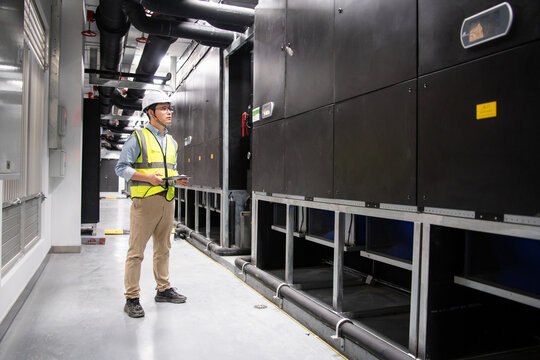 The engineer is in the industrial air conditioned room - Powered by Adobe