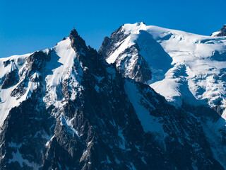 Aerial view of Glaciers cascading down the peak of  Le Mont Blanc France - Snow capped peaks on the...