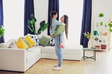 Happy parent and child bonding together in cozy home interior, highlighting their family...