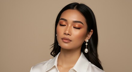 Woman with Eyes Closed Wearing Pearl Earrings in Studio
