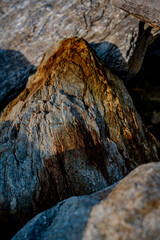 Textured Rock Surface With Layers Of Striated Minerals: Close-Up Of Weathered Geological Formation...