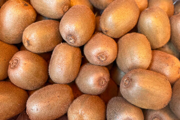Close-up of fresh kiwis, textured skin, organic produce, healthy food concept.