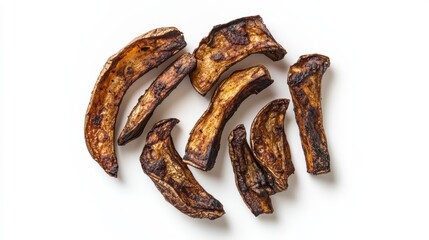 Obraz premium Roasted, crispy, dark brown, sweet potato slices arranged on white background.