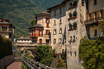 Historic Town of Chiavenna with Colorful Riverside Buildings and Stone Bridges: Scenic Italian Village Nestled Among Green Mountains and Flowing River