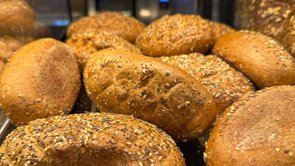 Freshly Baked Bread Rolls With Seeds in Bakery Window