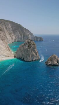 The drone aerial footage of Mizithres beach, Zakynthos Island, Greece. The two conical huge rocks, that bounce from the crystal blue waters in Keri, are called the Small and Big Mitzithra.