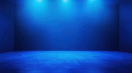 A blue room with a concrete floor and blue walls, illuminated by three spotlights.