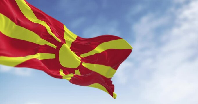 North Macedonia national flag waving in the wind on a clear day - Powered by Adobe