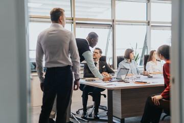 A multicultural group of business people engaged in a meeting, collaboratively brainstorming and discussing solutions in a modern office setting.