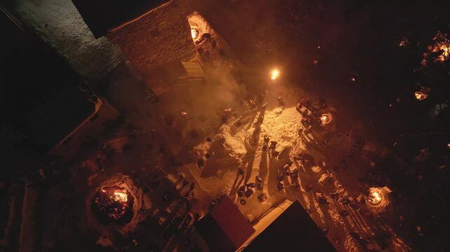Aerial top down view Lamproba festival, villagers gathered by symbolic bonfires near church and medieval tower in Mestia, Svaneti.Concept welcoming arrival of spring, invite the blessings of the gods
