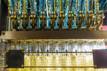 Automated Sunflower Oil Production Line in Modern Factory with Filling Nozzles and Transparent...