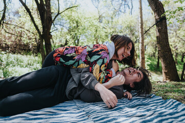 An energetic couple sharing a fun time outdoors in a beautiful forested area, displaying happiness...