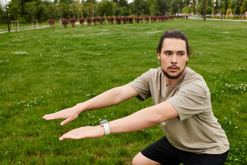 Young man training outdoors on a sunny day, focusing on fitness and strength
