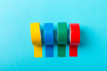 Insulating tape on a bright colored background. Set of different colors insulating tape. Reel...