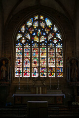 Small altar next to the stained-glass window inside the church of Locronan. Photograph taken in Locronan, Brittany, France