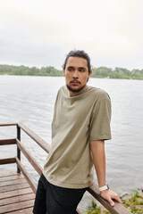 Fototapeta premium Sporty man enjoys outdoor workout by the serene lakeside in the early morning light
