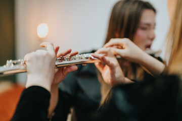 A detailed view of hands playing a flute in a studio setting, showcasing creativity and musical...