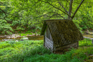 Image of an old wooden water mill for grinding grain on Cerna Valley, Romania, Europe	
