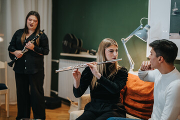 A gathering of young adults playing the flute and clarinet in a cozy home space, illustrating joy...