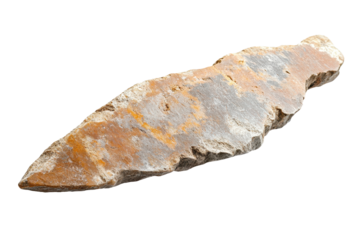 Primitive stone arrowhead discovered in archaeological site exhibits intricate features and historical significance from ancient tool-making practices