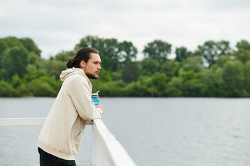 Sporty man enjoying outdoor workout by the lakeside on a cloudy day
