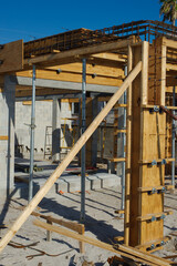 Modern Construction Framework with Wooden Beams and Steel Supports on Sunny Day in Florida. Construction site showcasing modern framework with wooden beams and steel reinforcements, emphasizing struct