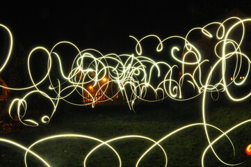 Creative light painting photography featuring colorful, swirling light trails against a dark...