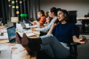 Diverse business professionals engage in a brainstorming session, strategizing and analyzing projects to meet deadlines.