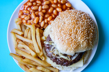 Homemade Beef Or Hamburger In White Seeded Bread Bun With Fries And Baked Beans In Tomato Sauce