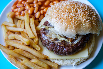 Homemade Beef Or Hamburger In White Seeded Bread Bun With Fries And Baked Beans In Tomato Sauce