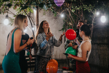 A lively gathering of young friends enjoying a celebration outdoors with colorful balloons and...