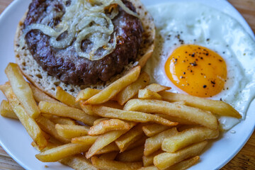 Homemade Ham Or Beefburger With Onions Frites And A Fried Egg