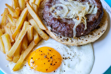 Homemade Ham Or Beefburger With Onions Frites And A Fried Egg