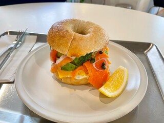 Smoked salmon, avocado, and cream cheese bagel, garnished with lemon – a perfect salmon sandwich...